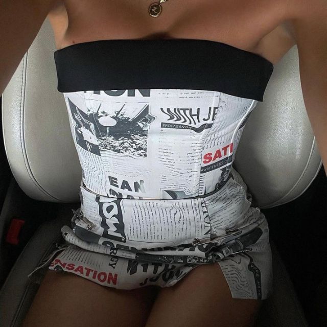 Clarissa - Off-the-shoulder playsuit with newspaper print