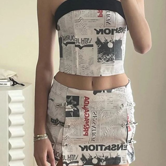 Clarissa - Off-the-shoulder playsuit with newspaper print