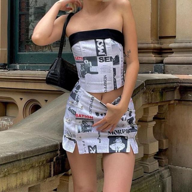 Clarissa - Off-the-shoulder playsuit with newspaper print