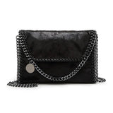 Isabel - Suede clutch with chain embellishment