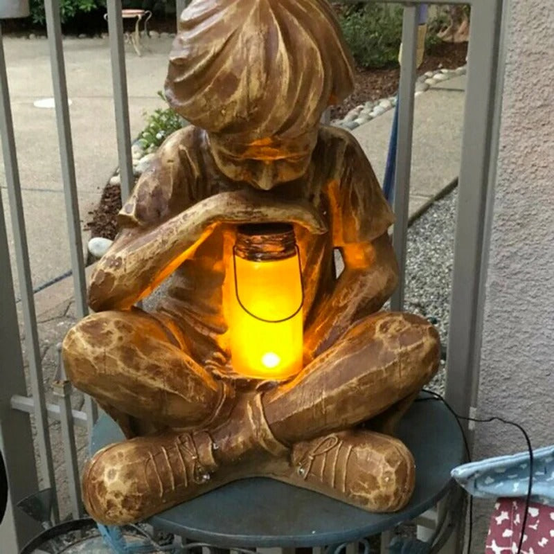 Boy with firefly light statue