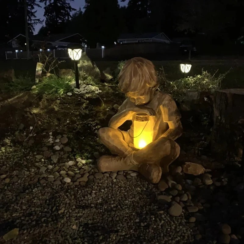 Boy with firefly light statue