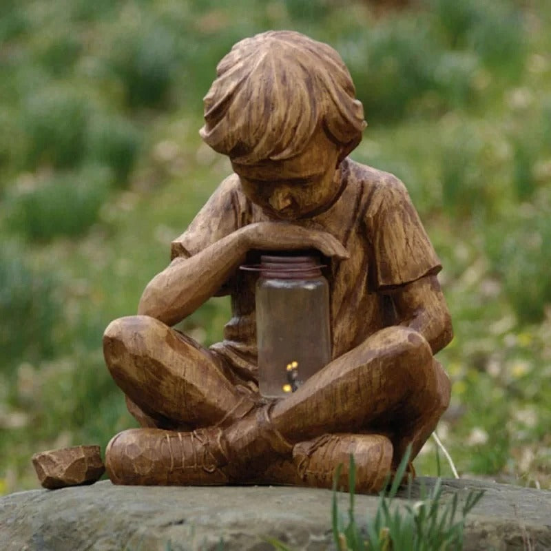 Boy with firefly light statue